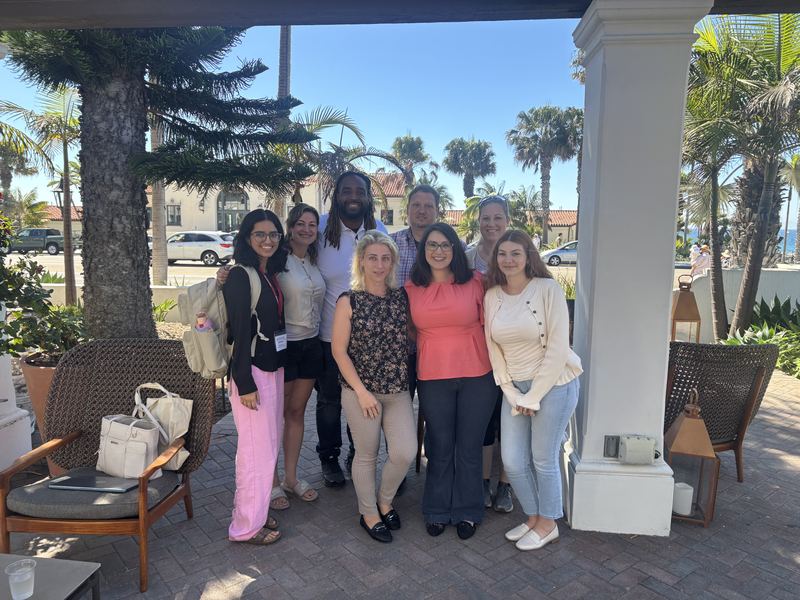The team together at a professional conference